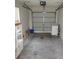 Spacious two car garage featuring laundry, storage shelves and an automatic garage door at 665 Oak Harbour Dr # 115, Altamonte Springs, FL 32701
