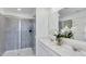 Modern bathroom with walk-in shower, double vanity and quartz countertops at 5636 Gingham Dr, Kissimmee, FL 34758