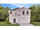 Charming two-story home with a clean design, well-manicured lawn, and beautiful trees at 5636 Gingham Dr, Kissimmee, FL 34758