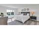 A bright main bedroom offers a plush bed, ample natural light, and tasteful decor at 5636 Gingham Dr, Kissimmee, FL 34758