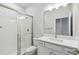 Modern bathroom featuring a glass-enclosed shower and updated vanity with ample lighting at 5950 Bristle Oak St, Mount Dora, FL 32757