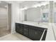 Bathroom featuring dual sinks and a large mirror at 5950 Bristle Oak St, Mount Dora, FL 32757