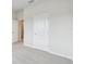 Bright bedroom features neutral carpet, fresh paint, and a classic interior door at 5950 Bristle Oak St, Mount Dora, FL 32757