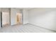 Bright bedroom featuring neutral walls, carpet, and two entryways to the ensuite bathroom and closet at 5950 Bristle Oak St, Mount Dora, FL 32757