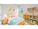 Colorful bedroom features playful decor, a built-in bookshelf, and a cozy rug at 5950 Bristle Oak St, Mount Dora, FL 32757