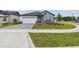 Inviting single-story home features a neatly maintained lawn and a driveway with a gray brick pattern at 5950 Bristle Oak St, Mount Dora, FL 32757