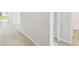 Hallway leading to the bathroom features wood floors and neutral walls at 5950 Bristle Oak St, Mount Dora, FL 32757
