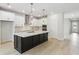 Spacious kitchen offers an island with pendant lighting, white cabinets, and stainless steel appliances at 5950 Bristle Oak St, Mount Dora, FL 32757