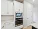 Bright kitchen features stainless steel appliances, white cabinets, and stylish backsplash at 5950 Bristle Oak St, Mount Dora, FL 32757