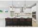 Modern kitchen featuring a large island, white cabinets, stainless steel appliances, and stylish pendant lighting at 5950 Bristle Oak St, Mount Dora, FL 32757