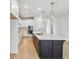 Well-lit kitchen with an island features stainless appliances, pendant lighting and a breakfast bar at 5950 Bristle Oak St, Mount Dora, FL 32757