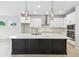 Contemporary kitchen features a large dark island with white countertop and stainless steel appliances at 5950 Bristle Oak St, Mount Dora, FL 32757