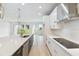 Modern kitchen boasts stainless steel appliances, sleek cabinets, and a spacious island overlooking the backyard at 5950 Bristle Oak St, Mount Dora, FL 32757
