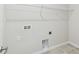 Functional laundry room includes hookups and a shelf for storage at 5950 Bristle Oak St, Mount Dora, FL 32757