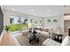 Bright living room with sliding glass doors to the backyard, neutral furnishings, and contemporary decor at 5950 Bristle Oak St, Mount Dora, FL 32757