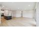 Bright living room featuring modern lighting fixtures and a kitchen with an island at 5950 Bristle Oak St, Mount Dora, FL 32757