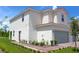 Exterior view showcasing the side of the townhome, featuring a well-maintained lawn and garden at 596 Bay Leaf Dr, Poinciana, FL 34759