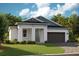 Charming single-story home with a covered entryway, attached garage, and well-manicured lawn at 6192 Sw 97Th St, Ocala, FL 34476