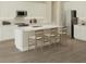 Bright kitchen featuring white cabinets, stainless steel appliances, and an island with barstool seating at 6192 Sw 97Th St, Ocala, FL 34476