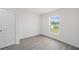 Light and airy bedroom with a large window and wood-look flooring at 639 Gila Dr, Poinciana, FL 34759