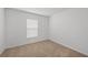 Empty bedroom with neutral carpet, window, and electrical outlets at 639 Gila Dr, Poinciana, FL 34759