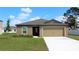 Charming one-story home with a well-maintained lawn and a two-car garage at 639 Gila Dr, Poinciana, FL 34759