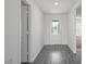 Bright hallway featuring wood-look flooring and a front door with glass design at 639 Gila Dr, Poinciana, FL 34759