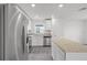 Bright kitchen featuring stainless steel appliances, granite countertops, and wood-look flooring at 639 Gila Dr, Poinciana, FL 34759