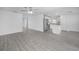 Open-concept living area with wood-look flooring that flows into the kitchen at 639 Gila Dr, Poinciana, FL 34759