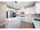 Modern white kitchen with stainless steel appliances, a gas range, and a center island at 7696 Somersworth Dr, Kissimmee, FL 34747