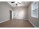 Main bedroom features a tray ceiling, a ceiling fan, wood floors, and double door closet at 7696 Somersworth Dr, Kissimmee, FL 34747