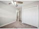 Bedroom featuring carpet, ceiling fan, and a double-door closet for ample storage at 1037 Waynesville Ave, Lakeland, FL 33801