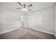 Inviting bedroom with soft carpet, a ceiling fan, and a spacious double-door closet at 1037 Waynesville Ave, Lakeland, FL 33801