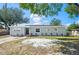 A charming single-story home features a well-manicured lawn, new landscaping, and a freshly painted exterior at 1037 Waynesville Ave, Lakeland, FL 33801