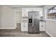 Kitchen with stainless steel refrigerator and white cabinets for a modern look at 1037 Waynesville Ave, Lakeland, FL 33801