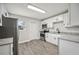 Bright kitchen with white cabinets, stainless steel appliances, and modern countertops at 1037 Waynesville Ave, Lakeland, FL 33801