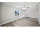 Bright living room featuring wood-look floors, a ceiling fan, and ample natural light at 1037 Waynesville Ave, Lakeland, FL 33801