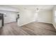 Spacious living room with modern flooring that flows seamlessly into the kitchen at 1037 Waynesville Ave, Lakeland, FL 33801