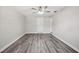 Spacious living room with wood-look floors and a modern ceiling fan for comfort at 1037 Waynesville Ave, Lakeland, FL 33801