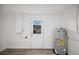 Utility room featuring new water heater and access to outside at 1037 Waynesville Ave, Lakeland, FL 33801