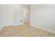 Neutral bedroom showcasing wood-look flooring, with door to a closet at 214 E Harding St, Orlando, FL 32806