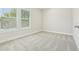 Well-lit bedroom with plush carpet and large windows creating a bright and airy atmosphere at 214 E Harding St, Orlando, FL 32806