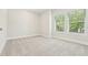 Well-lit bedroom with plush carpet and large windows offering a bright, airy space at 214 E Harding St, Orlando, FL 32806