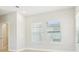 Bedroom with wood-look flooring, white walls, and windows to exterior views at 214 E Harding St, Orlando, FL 32806