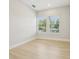 Bright bedroom with wood-look flooring and windows with views to exterior at 214 E Harding St, Orlando, FL 32806
