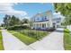 Charming exterior view of a two-story home with a black wrought iron fence and large driveway at 214 E Harding St, Orlando, FL 32806