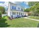 Beautiful two-story home featuring a manicured lawn, black wrought iron fence and a charming front porch at 214 E Harding St, Orlando, FL 32806