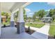 Inviting front porch with white columns and gray brick accents, leading to a meticulously maintained lawn at 214 E Harding St, Orlando, FL 32806