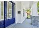 Stylish front door of home with sidelights, a mailbox, and white columns with gray brick accents at 214 E Harding St, Orlando, FL 32806
