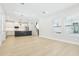 Bright living area with an open-concept design, modern flooring, and large windows at 214 E Harding St, Orlando, FL 32806
